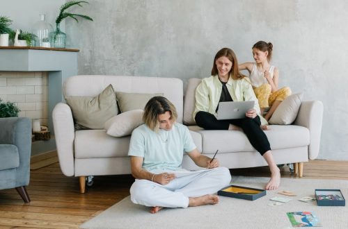 A family enjoying quality time together in a cozy living room setting, bonding and working.