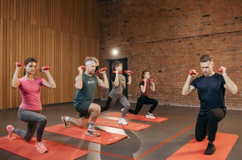 Indoor group workout session with dumbbells focusing on strength and fitness.
